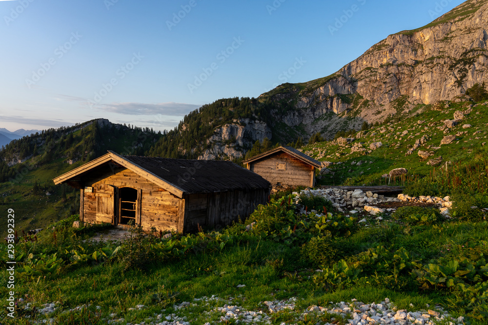tyrol hut hütte in sunrise with mountains on the background