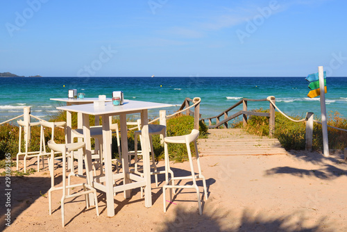 Table with chairs in a cafe overlooking the Muro beach (Playa de Muro) in Mallorca. Spain © vivoo