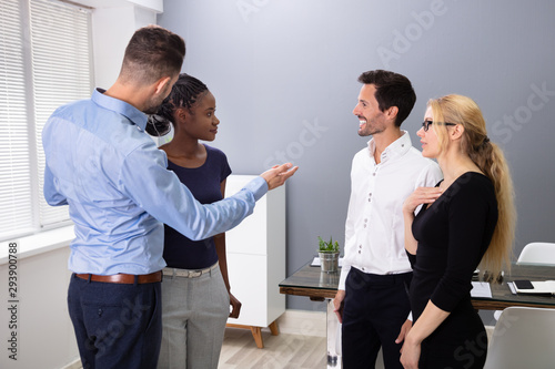 Male Executive Introducing New Hire Employee To His Team photo