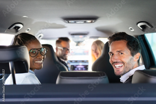 Happy Friends Sitting In Car Enjoying Road Trip photo