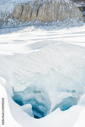 Ice crevasse hole in the rapidly melting Athabasca glacier of Columbia Icefield near the Icefields parkway in Jasper  Alberta  Canada   global warming and climate change concept