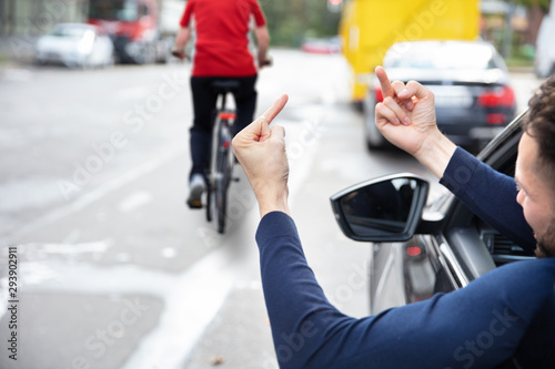 Angry Driver Showing Middle Finger To Woman Riding Bicycle © Andrey Popov