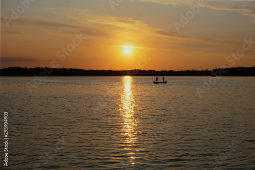 Fishing from a boat on a lake at sunset © PT Hamilton