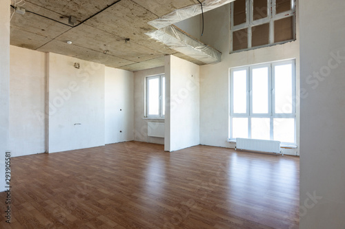 The interior of the spacious apartment without repair  with laminate flooring