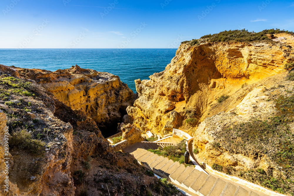 Scenic stairway leading down between the limestone rock of Algar Seco, Carvoeiro, Algarve, Portugal. Scenic stairway leading down between the limestone rock of Algar Seco, Carvoeiro, Algarve, Portugal.