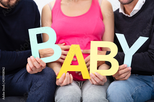 Group Of People Sitting Together Holding Alphabet Of Word Baby photo