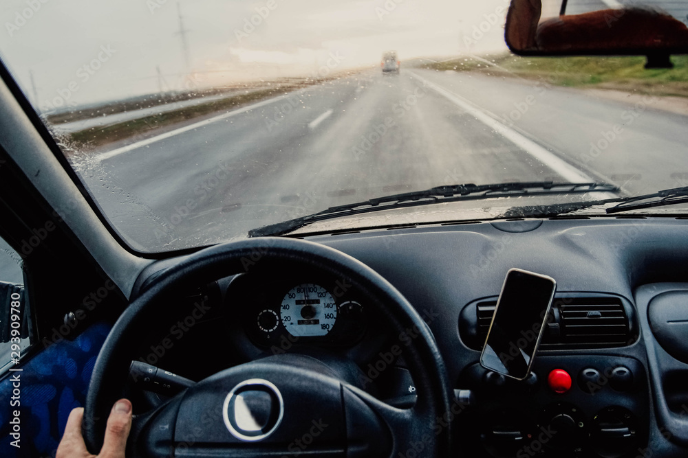 Obraz premium Driving a car on a sunny day. Business trip rain 