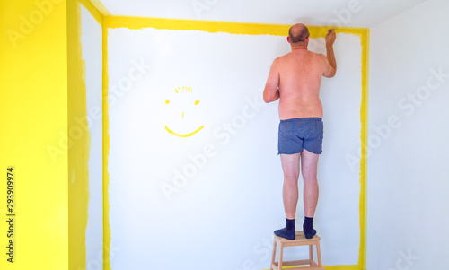 Man in underwear painting the walls of a room
