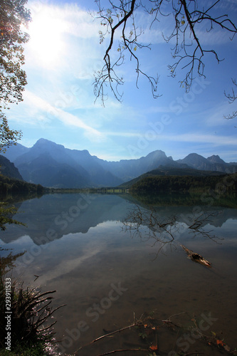 Scenic view of the shallow crystal clear water of the Almsee, near Grünau im Almtal, Oberösterreich, Austria, with a fallen tree rotting in the water