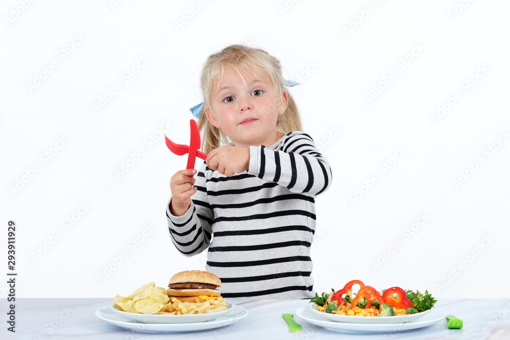 Little girl doesn't enjoy junk food. Healthy food, especially vegetables full of vitamins are essential for the kid's menu. Little girl doesn't enjoy junk food. Healthy food, especially vegetables full of vitamins are essential for the kid's menu.