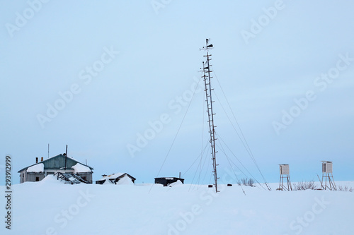 Abandoned weather station in a snow-covered tundra. Problems of conducting meteorological observations and weather forecasting in the far north in the Arctic. Chukotka  Siberia  Far East of Russia.