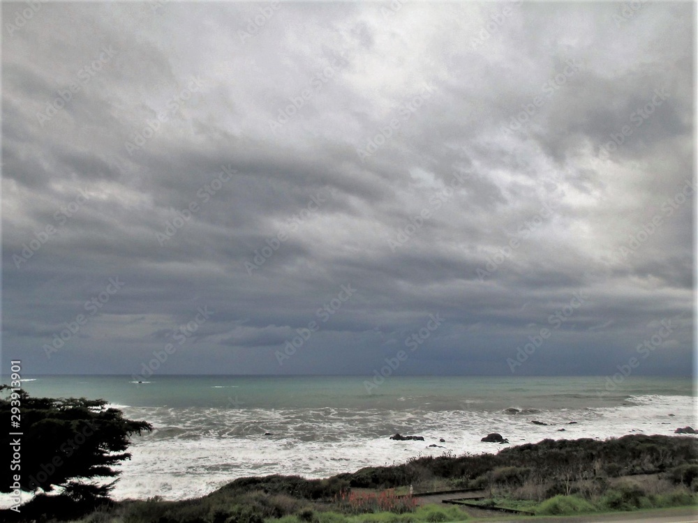 Rain clouds over shore and surf