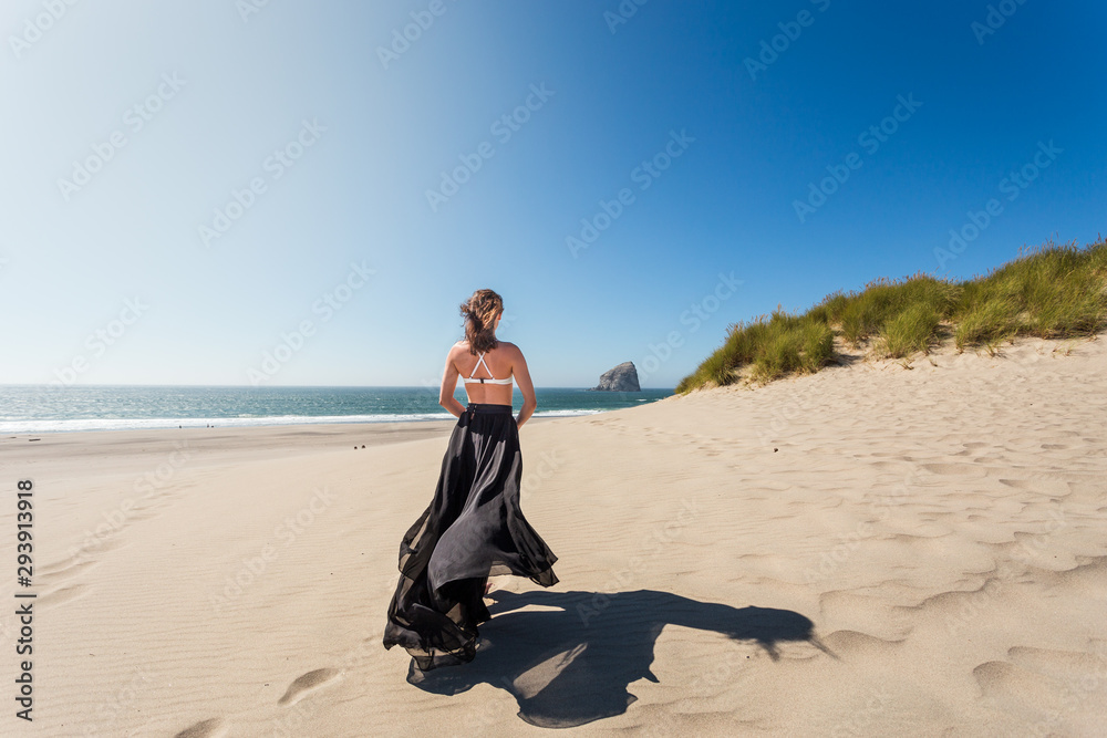 Shot of an attractive young woman on the beach of the Oregon coast near Lincoln City. Shot of an attractive young woman on the beach of the Oregon coast near Lincoln City.