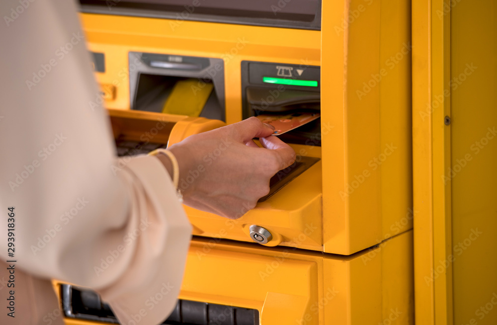 Hand of Business women using credit cards to withdraw money from ATMs Hand of Business women using credit cards to withdraw money from ATMs
