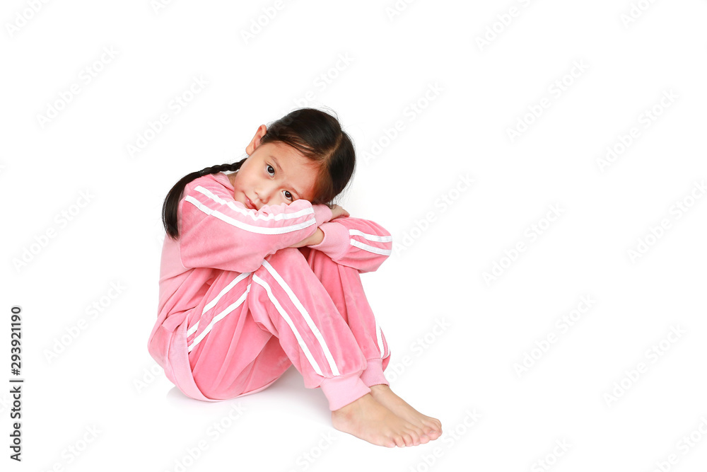 Peaceful little Asian child girl in pink tracksuit or sport cloth Sitting and hugging knees over white background with looking at camera. Peaceful little Asian child girl in pink tracksuit or sport cloth Sitting and hugging knees over white background with looking at camera.