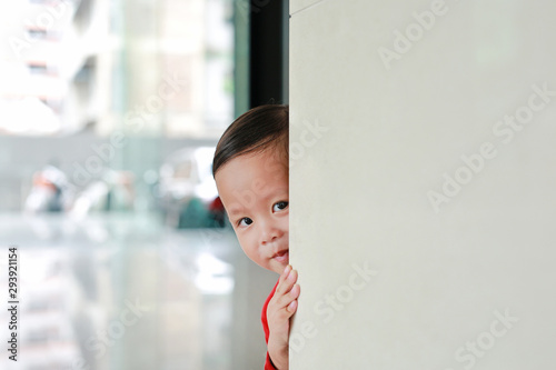 Photography Smiling little Asian baby boy hide behind a corner room