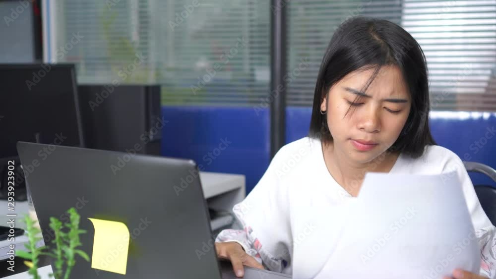 serious worried businesswoman or student asian reading notification paperwork or documents sitting in a desktop at office with information laptop, working in sad and anxiety about accounting corporate serious worried businesswoman or student asian reading notification paperwork or documents sitting in a desktop at office with information laptop, working in sad and anxiety about accounting corporate