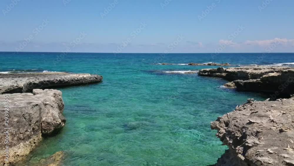 Calm waves and cliffs. Sunny spring day on the Adriatic Sea coast with blue sky at the background. Calm waves and cliffs. Sunny spring day on the Adriatic Sea coast with blue sky at the background.