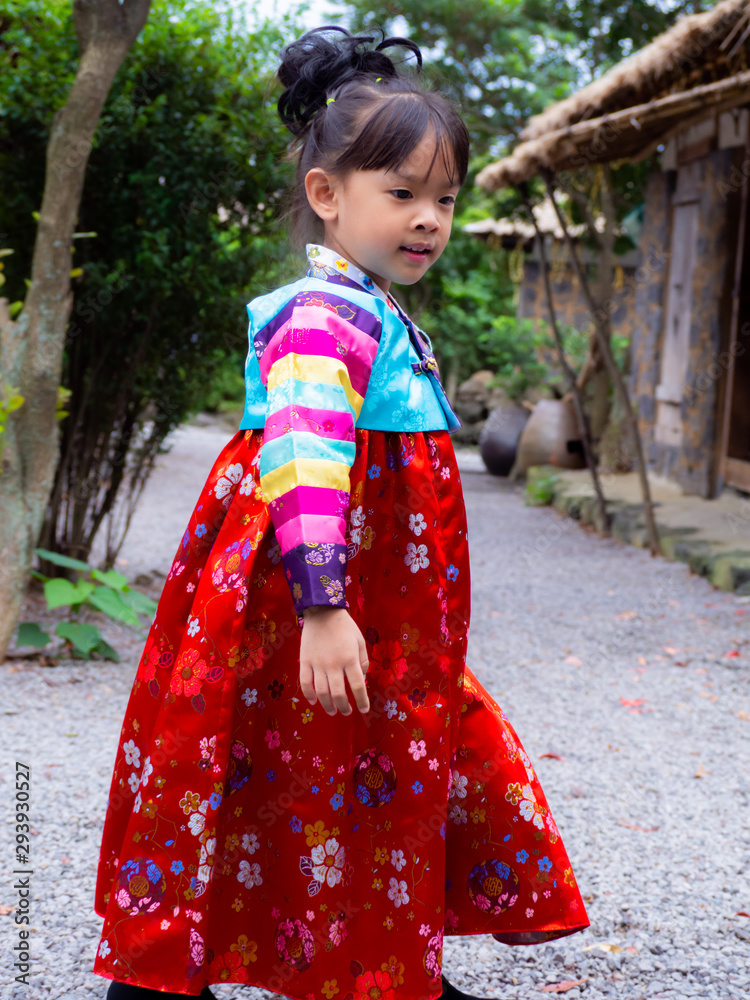 Asian little girl wearing a Korean Traditional Hanbok dress at Ancient village Asian little girl wearing a Korean Traditional Hanbok dress at Ancient village