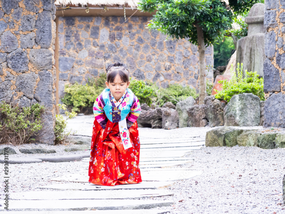 Asian little girl wearing a Korean Traditional Hanbok dress at Ancient village Asian little girl wearing a Korean Traditional Hanbok dress at Ancient village