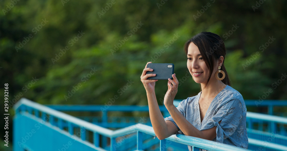 Woman take photo on cellphone at outdoor