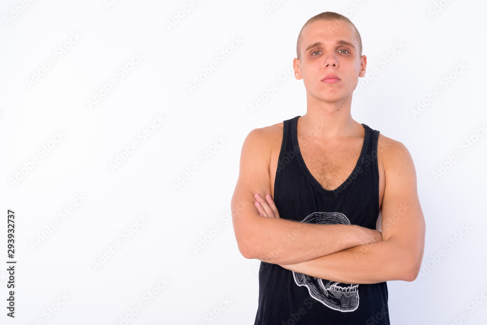 Portrait of young bald rebellious man with arms crossed Portrait of young bald rebellious man with arms crossed