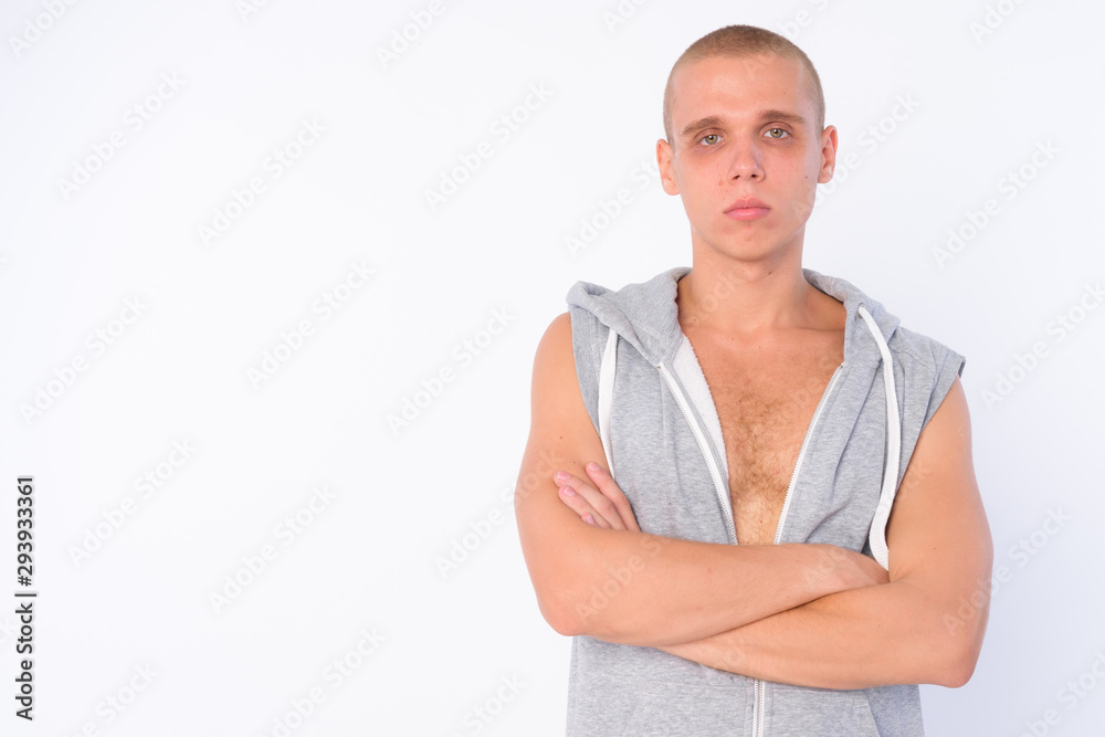 Portrait of young bald rebellious man with arms crossed Portrait of young bald rebellious man with arms crossed