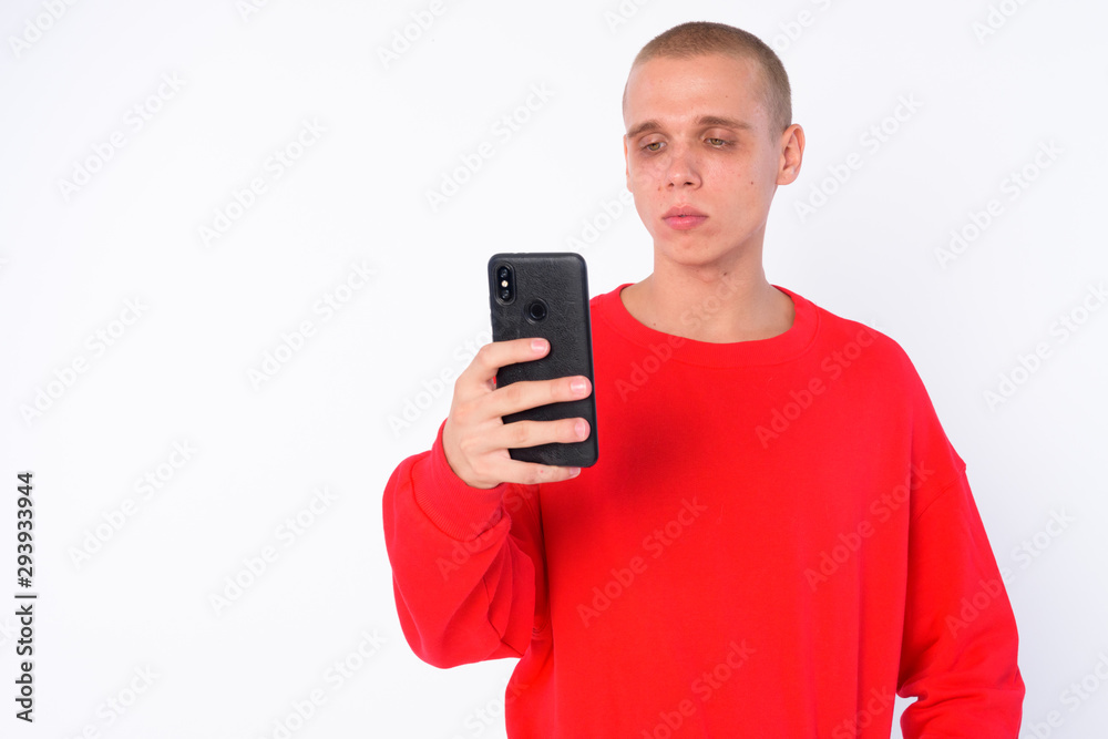 Portrait of young bald man using phone Portrait of young bald man using phone