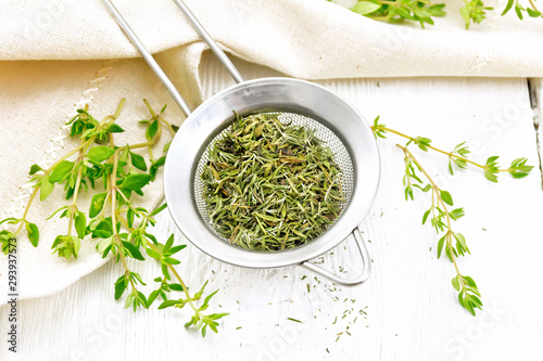 Bild auf Leinwand Thyme fresh and dry in strainer on table