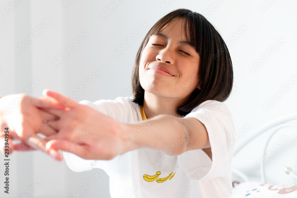 Asian girl stretch oneself in the morning on bed. Asian girl stretch oneself in the morning on bed.