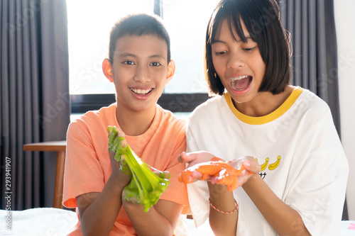 Sibling Hands Holding Homemade Toy Called Slime or Goop, Kids having fun and being creative by science experiment