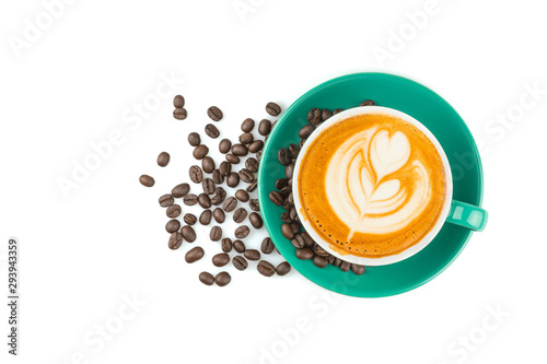Top view of hot latte coffee with latte art and roasted coffee beans in a green cup isolated on white background.