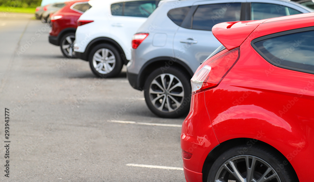 Closeup of rear, back side of red car with other cars parking in outdoor parking area. Closeup of rear, back side of red car with other cars parking in outdoor parking area.