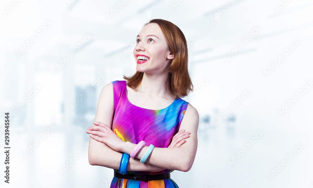 Smiling woman standing with folded arms