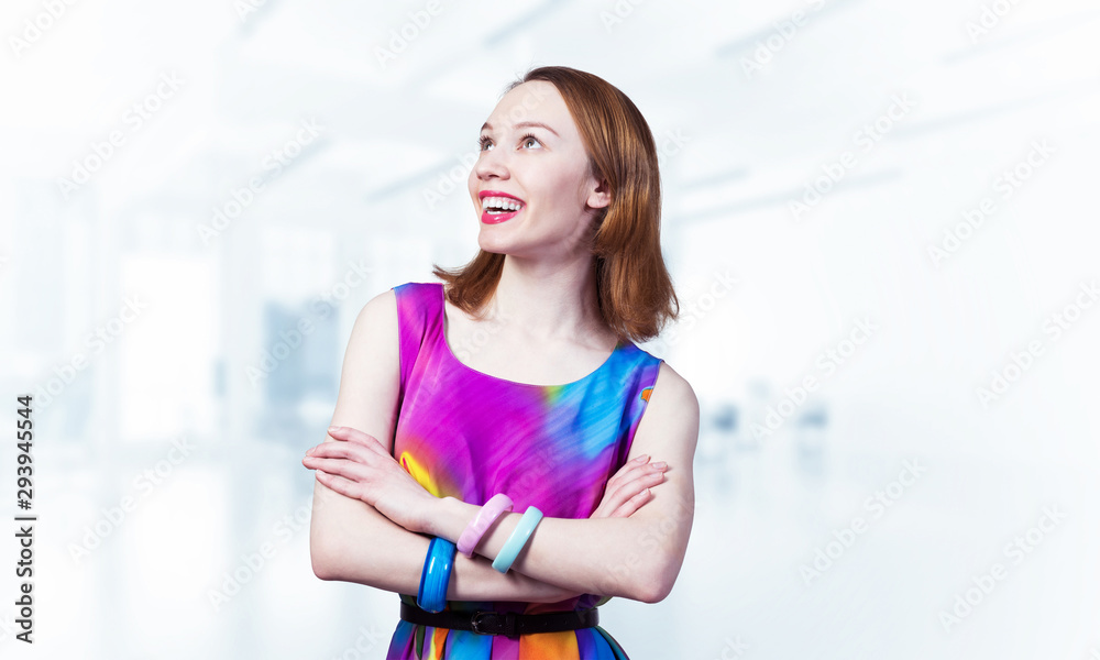 Smiling woman standing with folded arms Smiling woman standing with folded arms