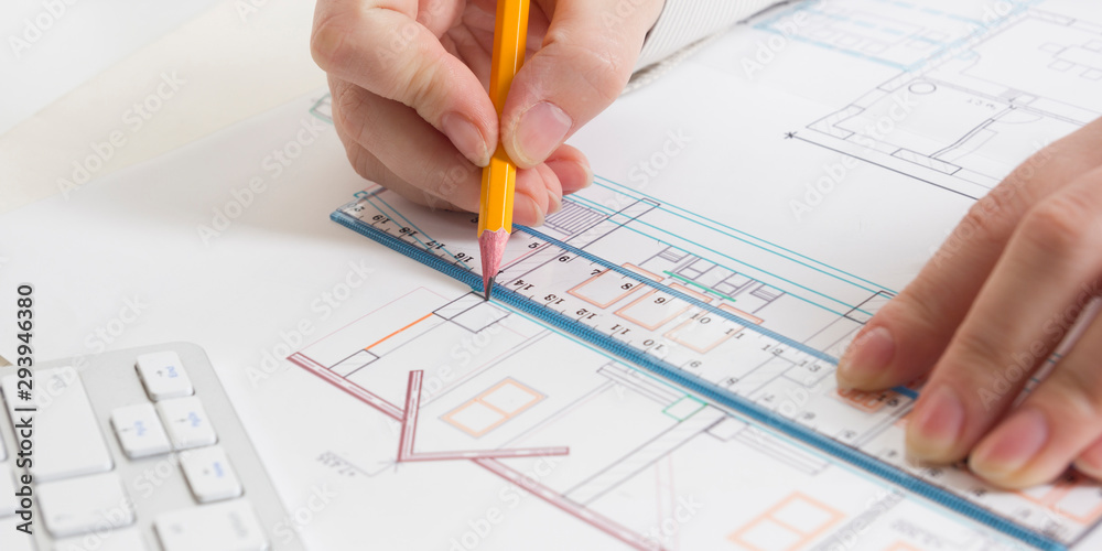 Architects working on blueprint, real estate project. Architect workplace. Construction concept. Engineering tools. Architects working on blueprint, real estate project. Architect workplace. Construction concept. Engineering tools.