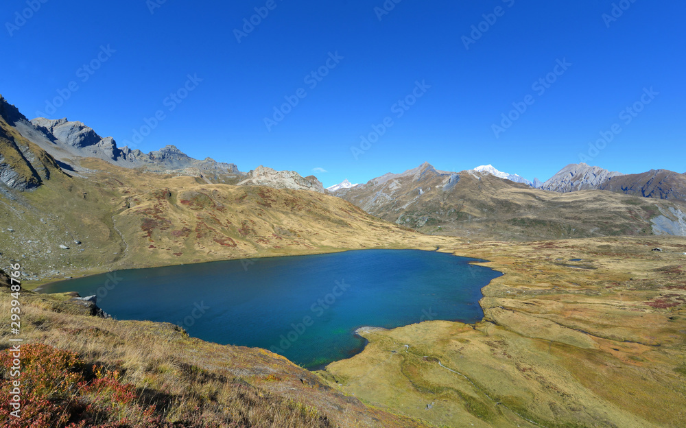 beautiful lake in alpine mountain in autumn under blue sky