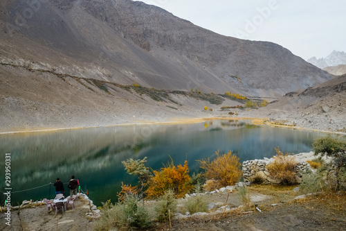 Beautiful landscape scenery of reflection in water of Borith lake against Karakoram mountain range. Autumn season in Gulmit Gojal, Hunza Valley. Gilgit Baltistan, Pakistan. photo