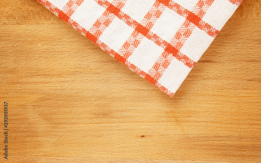 Red tablecloth on wooden table background Red tablecloth on wooden table background