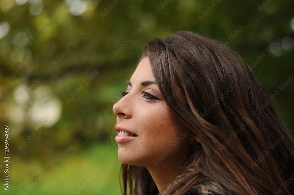 Portrait of a girl with long curly hair in a park Portrait of a girl with long curly hair in a park