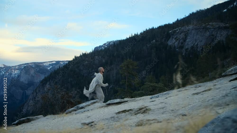 Man running up the rocks at Yosemite National Park, USA Man running up the rocks at Yosemite National Park, USA