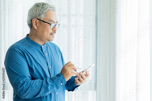 Asian Business Old Man with Gray Hair Wearing Glasses and Working in Office