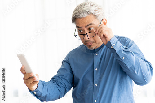 Asian Business Old Man with Gray Hair Wearing Glasses and Working in Office
