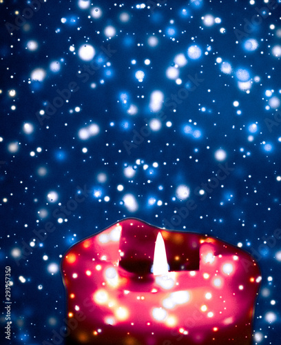 Photography Red holiday candle on blue sparkling snowing background, luxury branding design