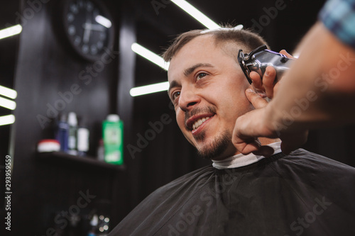 Mature man getting a new haircut at the barbershop