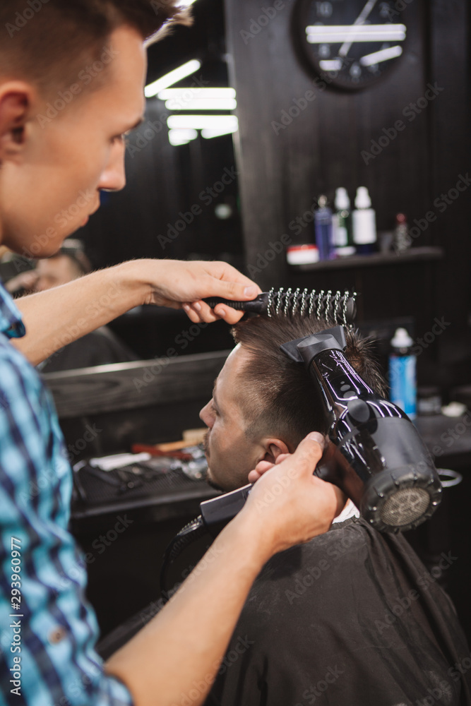 Mature man getting a new haircut at the barbershop Mature man getting a new haircut at the barbershop