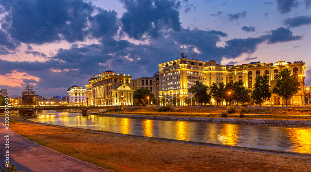 Downtown of the Skopje at sunset with city lights reflected on Vardar river. North Macedonia.