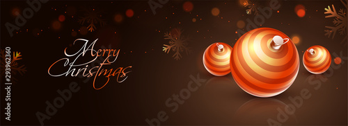 Merry Christmas celebration concept with golden baubles on brown bokeh background. Website header or banner design.