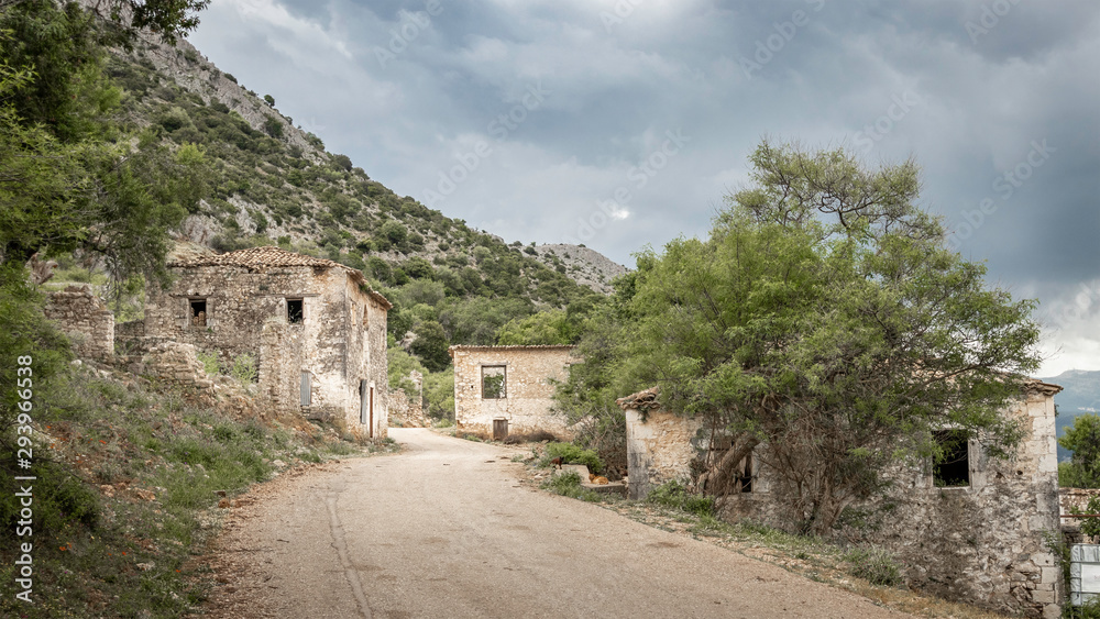 road through abandoned earthquake village Palia Plagia in Greece, with ruined houses