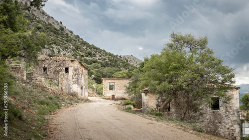 road through abandoned earthquake village Palia Plagia in Greece  with ruined houses